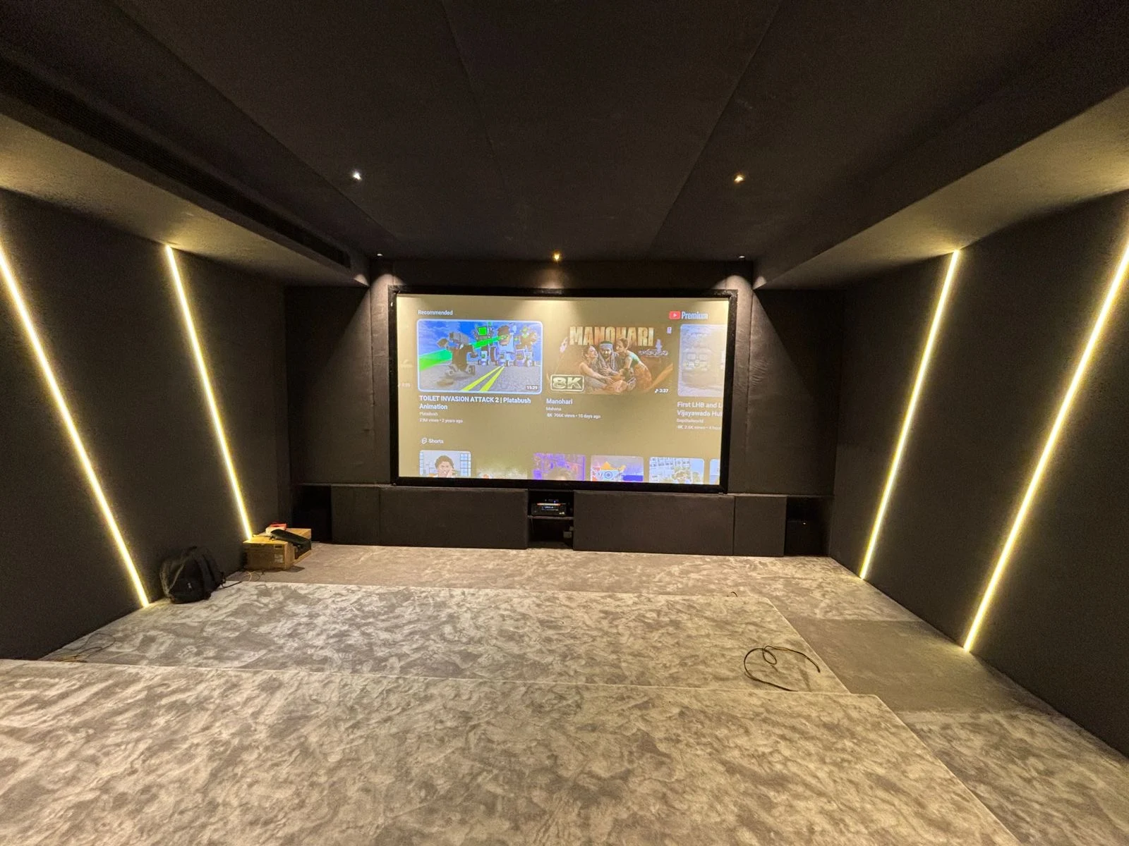 SLV home theatre with a large projection screen and illuminated acoustic wall panels